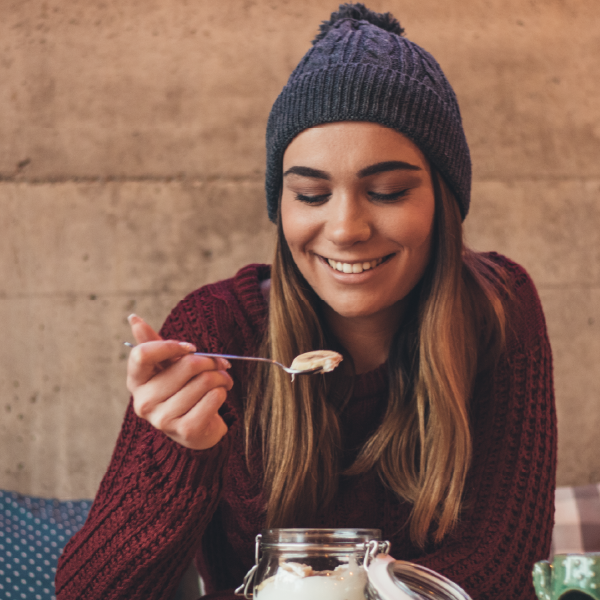 image of woman enjoying a yogurt