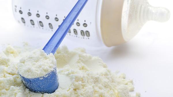 infant formula with scoop and baby bottle